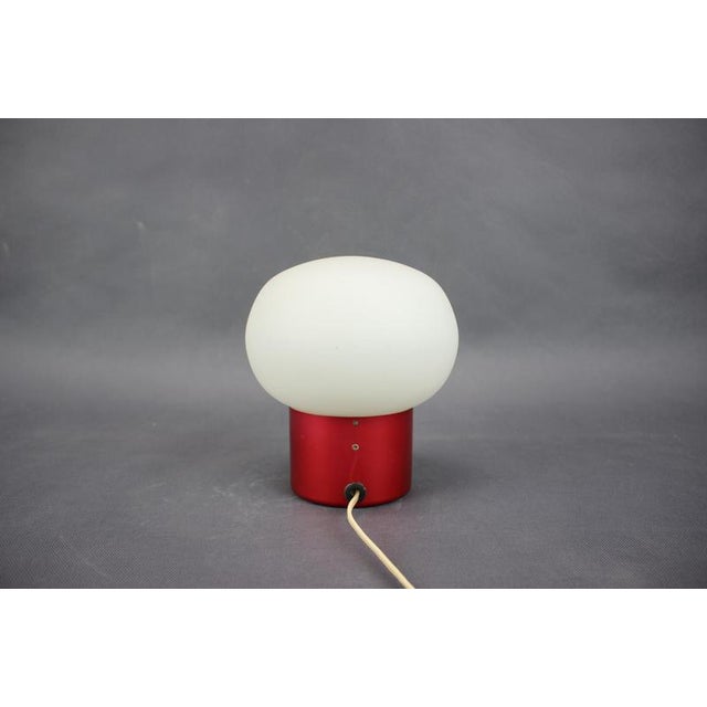Vintage Space Age table lamp produced in Czechoslovakia during the 1970s. This striking lamp features a burgundy red...