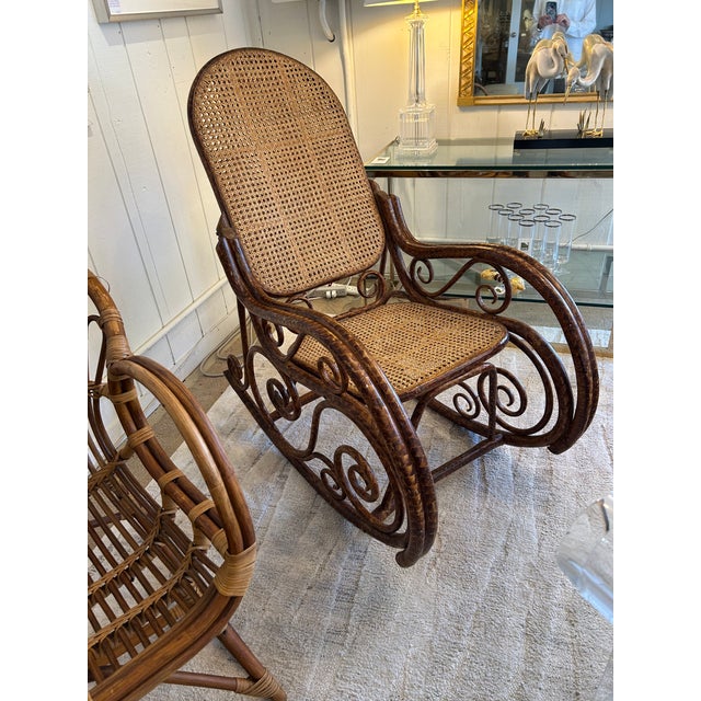 Great looking comfortable rattan rocking chair having double caned back and seat and handsome curlicue design. arm height...