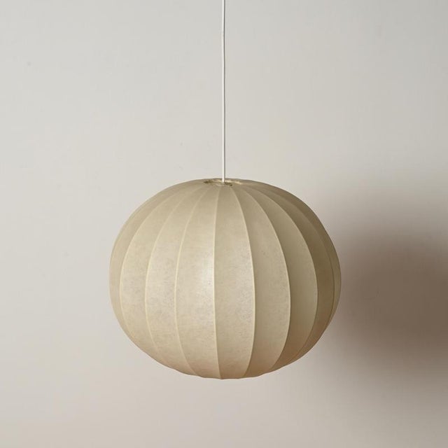Wonderful mid-century cocoon pendant lamp in beige resin and steel. This gorgeous ceiling light was designed by achille...