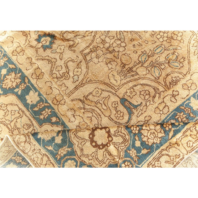 This turn of the century Persian Tabriz antique carpet has an all-over design of linked quatrefoil cusped medallions...