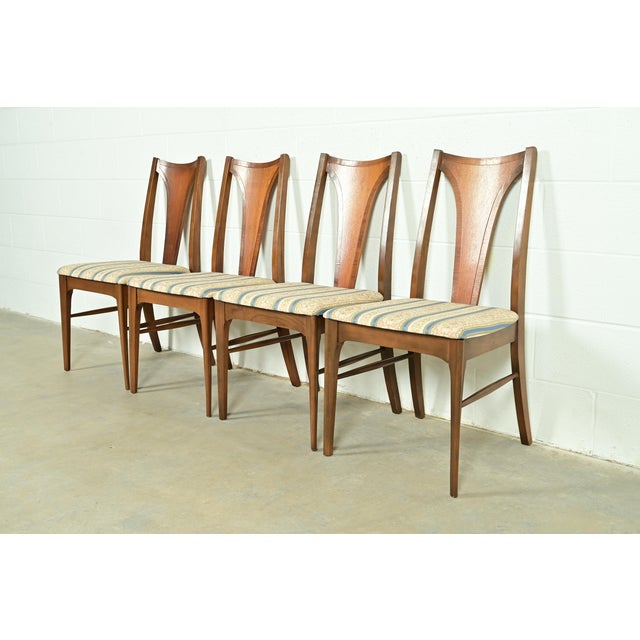 A gorgeous set of four Mid-Century Modern dining chairs By Broyhill Brasilia USA, 1960s Sculpted walnut frames, with...