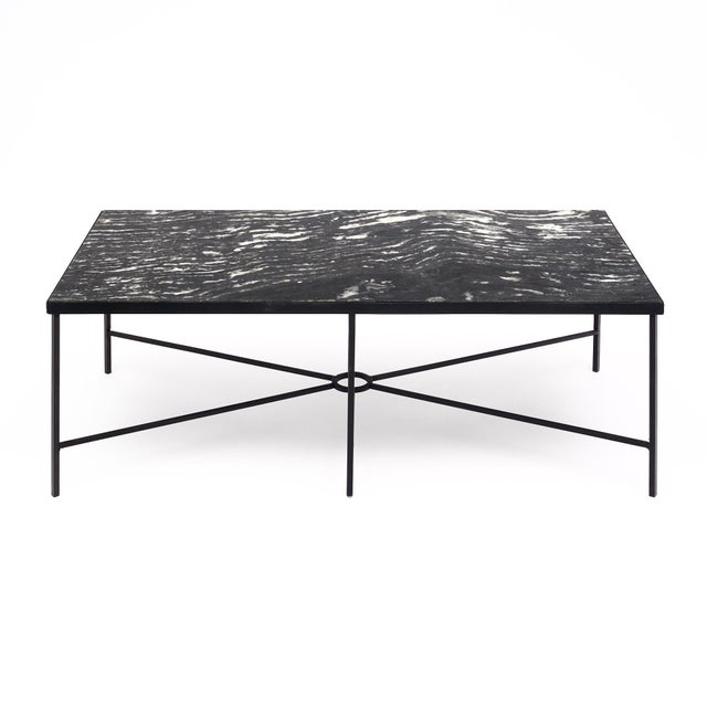 Coffee table from. The structure of the table is steel with a six-armed stretcher. The top is a striking black and white...