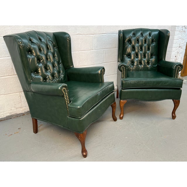 Striking Vintage Wing-Backed Tufted Chesterfield Lounge Chairs, a perfect blend of classic English design and bold,...