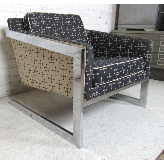 Squared mid-century lounge chair with wild vintage fabric and polished chrome frame. Dimensions Height: 26.5" Width: 30"...