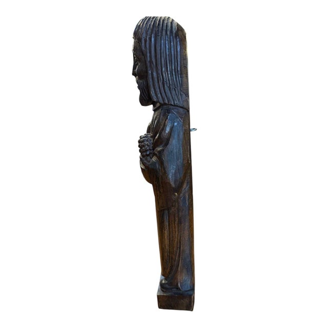 Beautiful hand carved antique saint. His hands are holding a carved staff and what could be a pinecone or piece of fruit,...