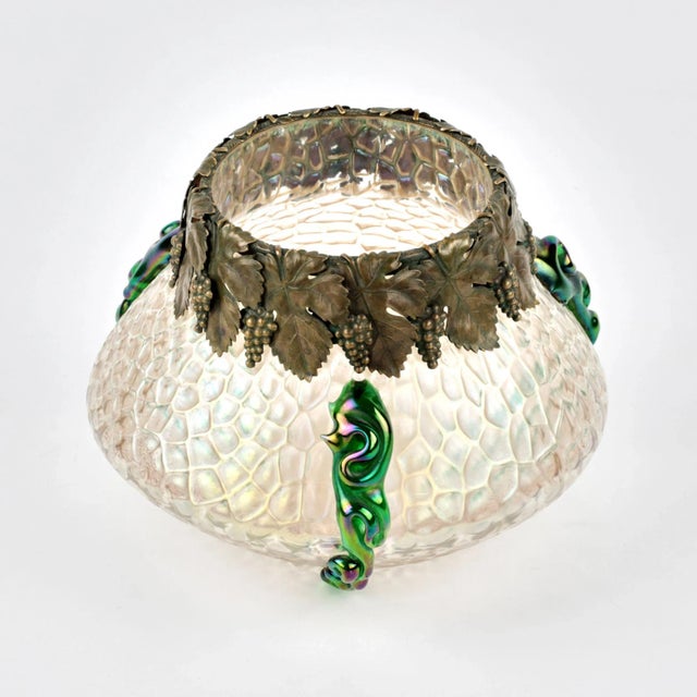 Art Nouveau glass vase. OK. 1900 g. Transparent glass with iridescent ornament, fused glass mass of green color, neck with...