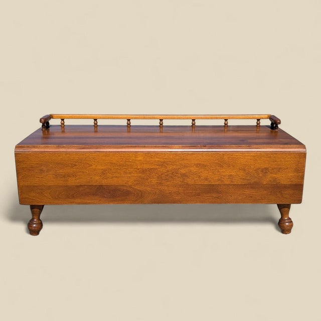 Bring timeless design into your home with this Early American coffee table in solid wood with a convenient drop-leaf...