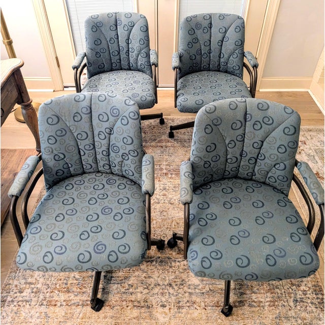 This set of rolling, swivel office/dining chairs have a postmodern design aesthetic and were likely made in the 80s or...