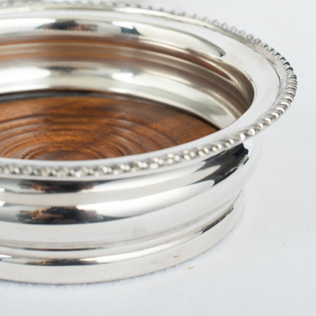 Elevate your dinner parties! An appealing pair of large antique English, Georgian styled silver plate and mahogany...