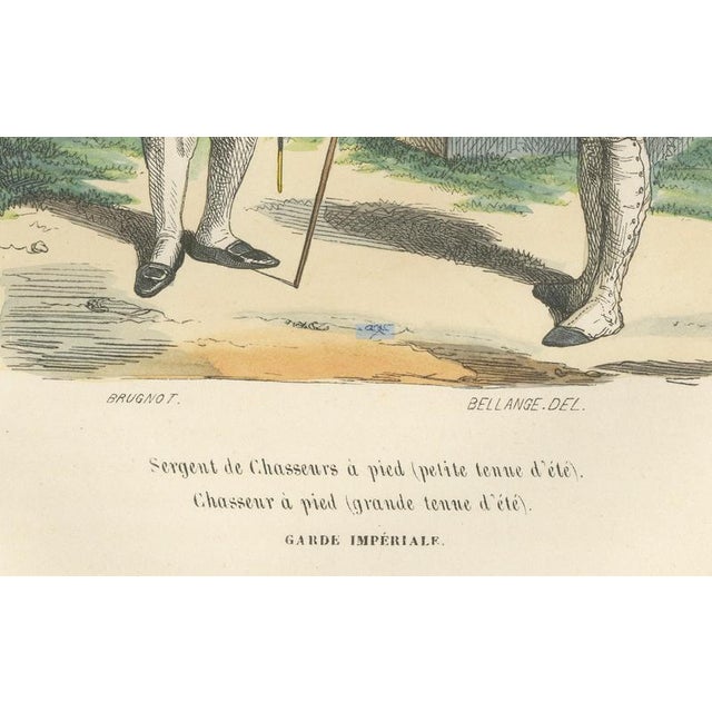 This refined military costume plate depicts two ranks of Napoleon Bonaparte’s elite Chasseurs à pied of the Imperial...