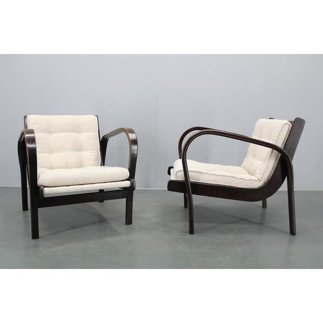 A refined pair of Mid-Century Modern lounge chairs designed by Kropáček & Koželka, produced in Czechoslovakia in the...