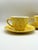 A cheerful vintage set of yellow spongeware teacups with matching saucers, made in the USA for Royal Copenhagen under the...