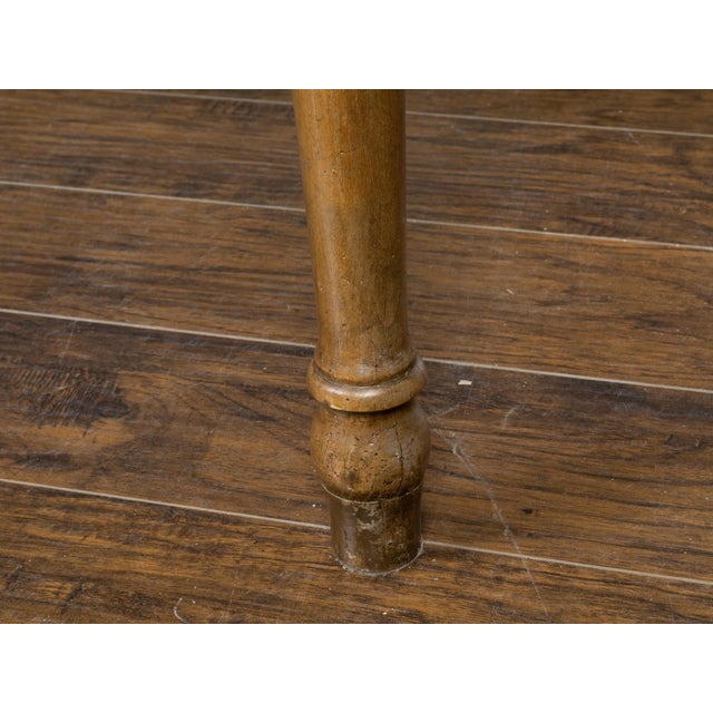 A French walnut farm dining table from the 19th century, with distressed top, turned legs and great rustic character....