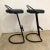 Pair of Postmodern cantilevered barstools rendered in black painted tubular metal frames with a black rubber seat, made in...