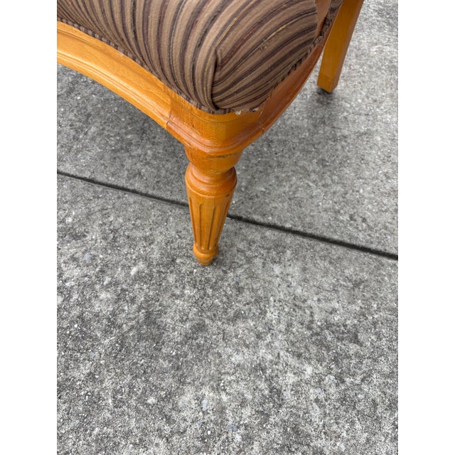 Oversized French Louis XVI Style chair in a Neutral Striped Color with a Light Colored Solid Wood Frame with Accents .
