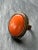 Vintage costume cocktail ring with a bold coral-hued resin stone set in a bronze-tone metal. The oversized setting and...