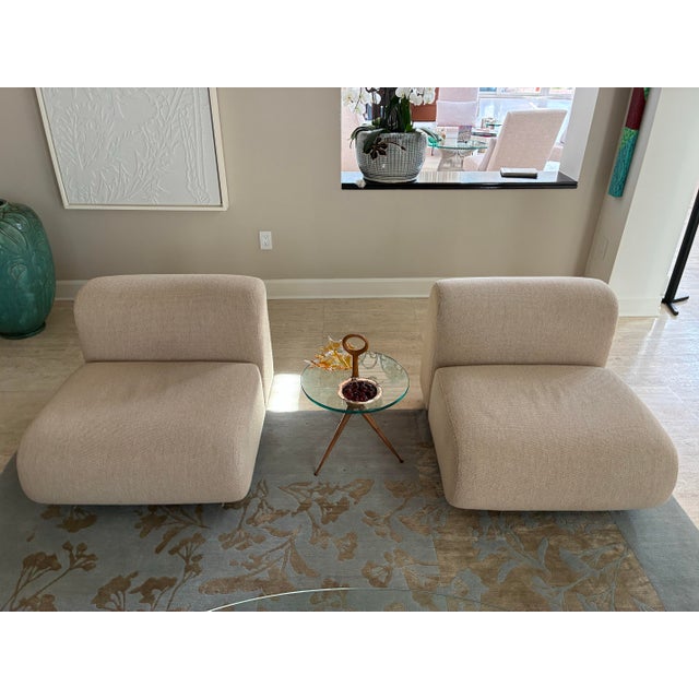 This pair of elegant lounge chairs has simple clean lines, gentle sloping curves and makes a beautiful and sophisticated...