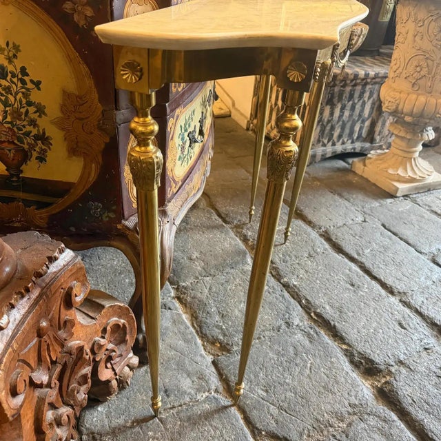 This exquisite 1950s Mid-Century Modern console table is a masterclass in Italian-inspired elegance and slender...