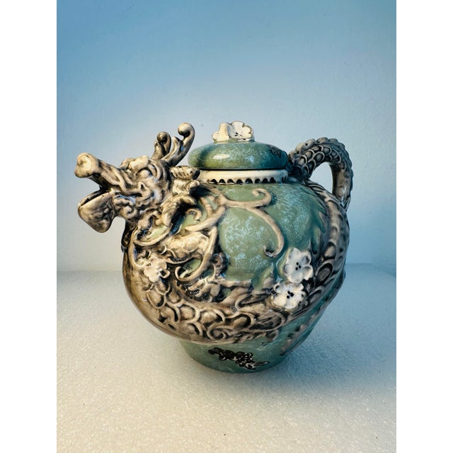 A striking sculptural teapot designed by artist Heather Goldminc for Blue Sky Ceramic, featuring an intricately modeled...
