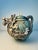 A striking sculptural teapot designed by artist Heather Goldminc for Blue Sky Ceramic, featuring an intricately modeled...