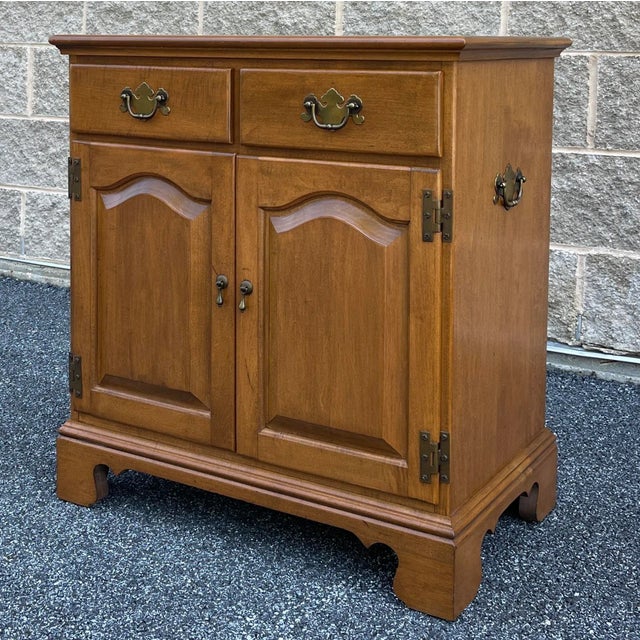 A vintage Ethan Allen by Baumritter Heirloom Maple American Traditional storage piece consisting of two small drawers...