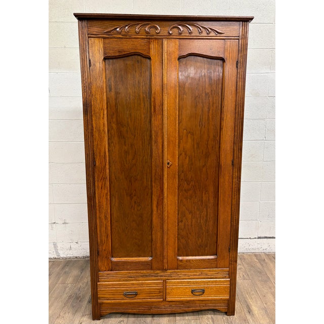 This is a stunning and rare antique tiger oak carved Victorian armoire, wardrobe, or closet, believed to be from the late...