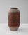 This 20th Century German ceramic jug features an intricate blend of carved floral motifs and geometric patterns,...