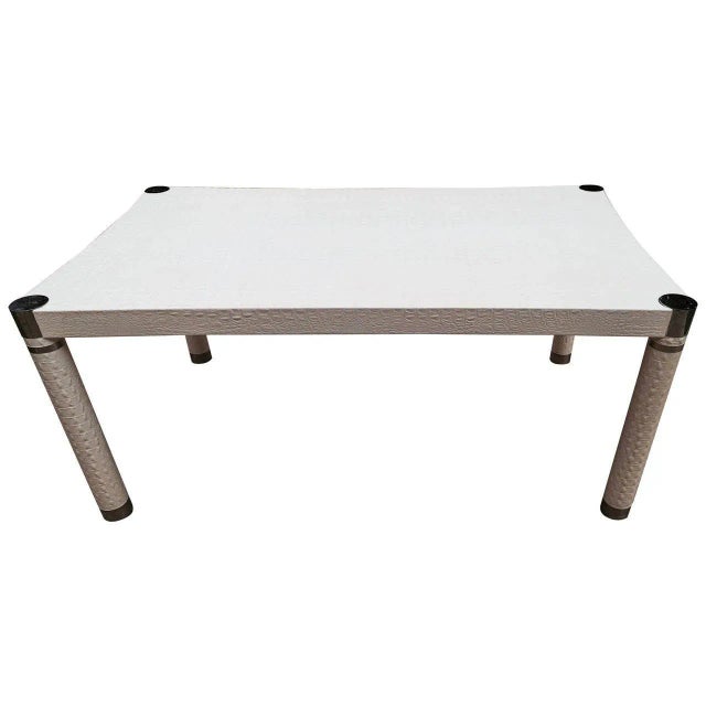 Glamorous signed Karl Springer dining table of white faux crocodile leather with chrome accents. Bearing wood Karl...
