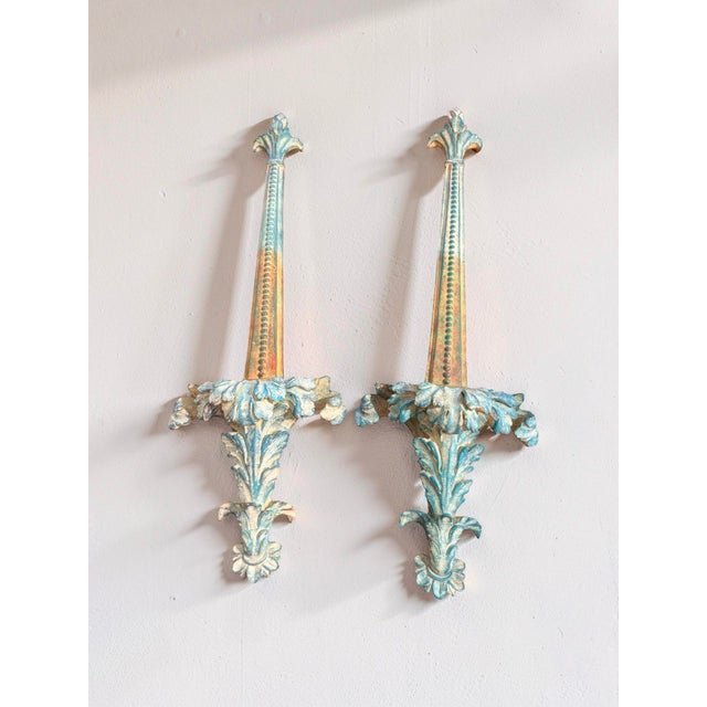 An impressive pair of oversized vintage architectural wall ornaments with Neoclassical and Hollywood Regency influence....