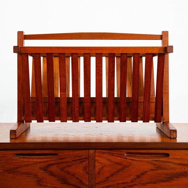 Sleek Danish modern magazine rack holder. This mid century modern modern solid teak magazine rack by unknown designer....