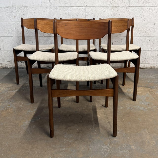 A set of six Danish teak dining chairs attributed to Erik Buch, dating to the 1960s. The chairs have a light, sculptural...