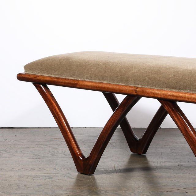 This elegant Mid Century Modern walnut and taupe bench was realized in Italian, circa 1950. It features a sculptural high...
