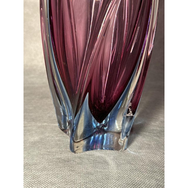 A beautiful heavy hand-turned Murano glass vase featuring soft pink-violet tones transitioning into a blue base. The wavy,...
