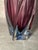 A beautiful heavy hand-turned Murano glass vase featuring soft pink-violet tones transitioning into a blue base. The wavy,...