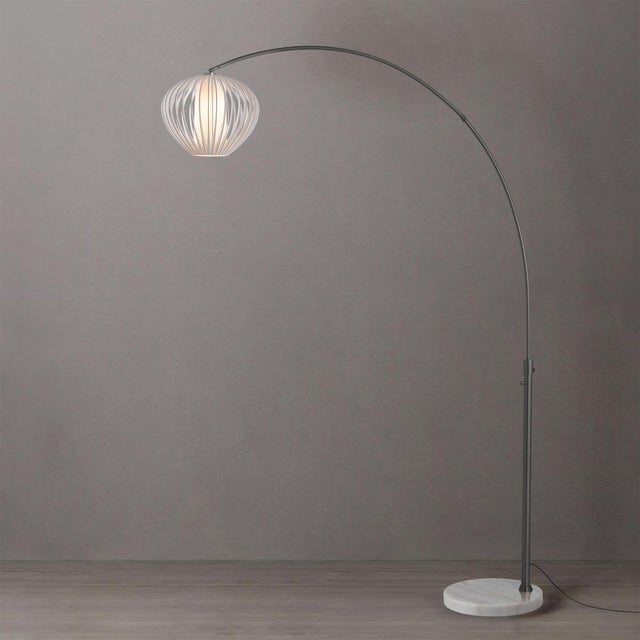 The Float Arc Lamp is a sophisticated lighting solution featuring a Black Nickel steel body and a Sphere White Satin steel...
