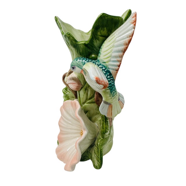 Add a touch of vintage elegance to your home with this beautiful Fitz and Floyd vase from the 1987 Hummingbird and...