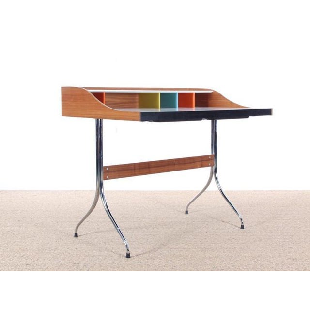 George nelson “home desk” for vitra. Designed in 1958. Walnut and painted wood. Chromed metal base. Two front valet...