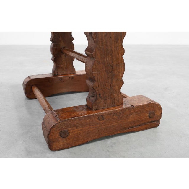A powerful and atmospheric 17th‑century French monastery coffee table crafted in solid oak, distinguished by its...