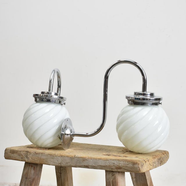 A pair opaline wall lights with a chrome swan neck wall bracket and gallery. The opaline glass shades have an unique swirl...