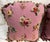 Pair of decorative pillows featuring a charming floral design on a soft pink background, finished with tassel trim....