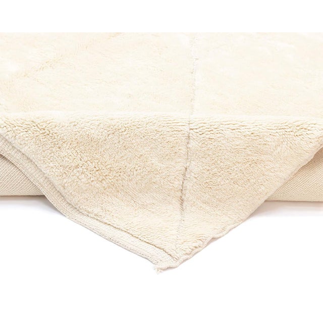 Elegant hand-knotted rug featuring a sophisticated diamond pattern in a subtle Ivory hue, providing a luxurious and soft...