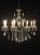 8 light, single tier Antique Black finish with gold accents chandelier and Optic Crystal trimmings White Glass Candle Slips