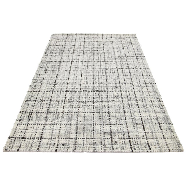 This beautiful Felt hand-woven wool rug is part of our Westport Collection. It has an Ivory color field and a brown and...