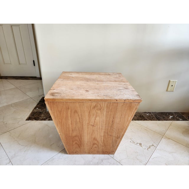 Introduce a touch of unique, geometric charm to your living space with this eye-catching pyramid-shaped wooden chest....