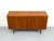 Compact and practical teak sideboard with two lockable cabinet doors. The interior is veneered in light maple and features...