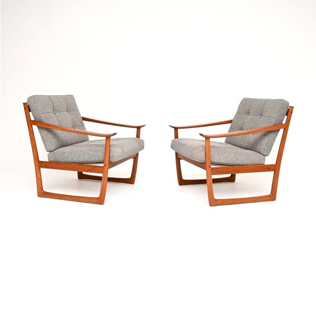 A stunning, very rare and extremely comfortable pair of Danish teak armchairs by Peter Hvidt and Orla Mølgaard-Nielsen....