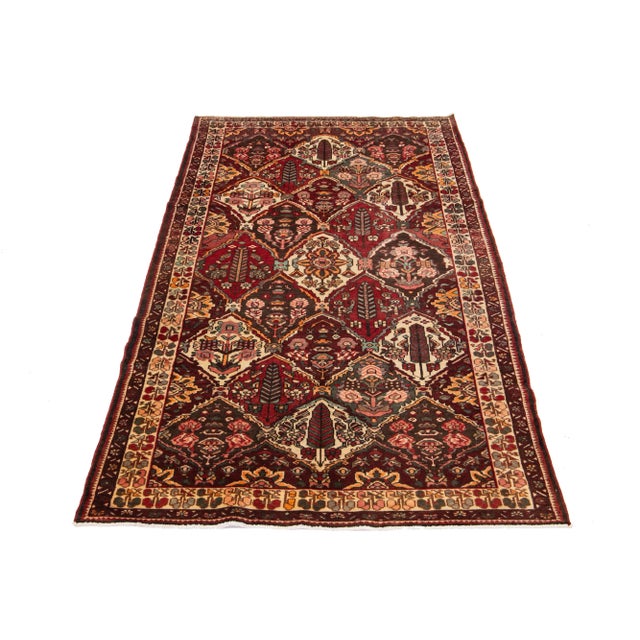 Vintage Handmade Persian Bakhtiari Wool rug with multicolor accents in an allover floral pattern. This rug measures 5'3" x...