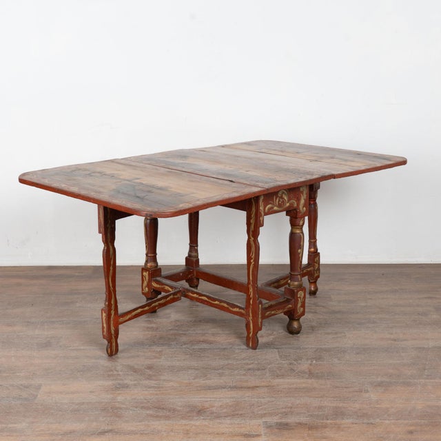 Early 19th century Dutch drop leaf table, crafted in pine and retaining its original hand painted finish. The surface...