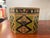This is an antique wood octagonal trinket box. It has hand painted folk art detailing. It has a latch lock to keep it...