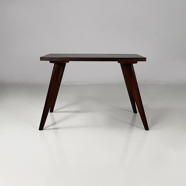 Italian mid-century modern coffe table in dark wood, 1960s Coffee table made entirely of dark wood. The square top is...